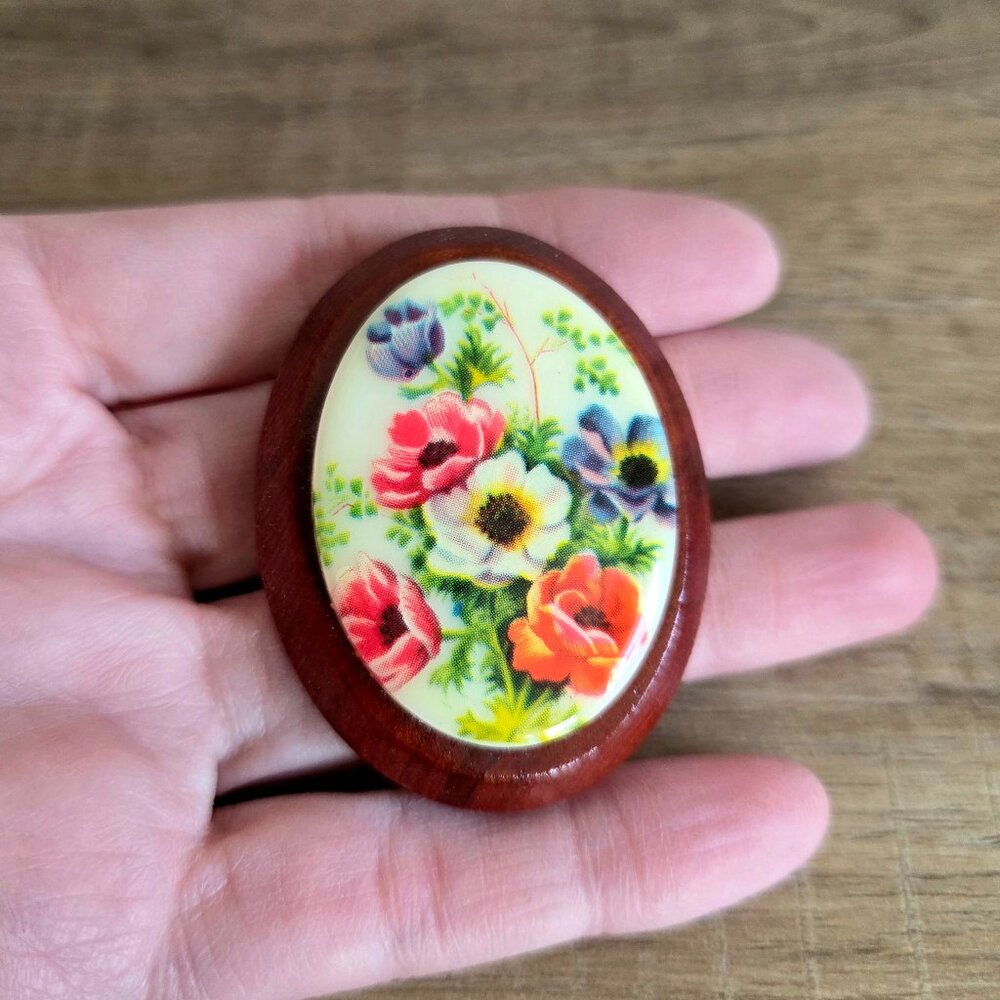Vintage large oval plastic and wood cameo brooch with red purple white flowers.